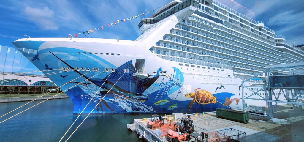 front of large cruise ship in port