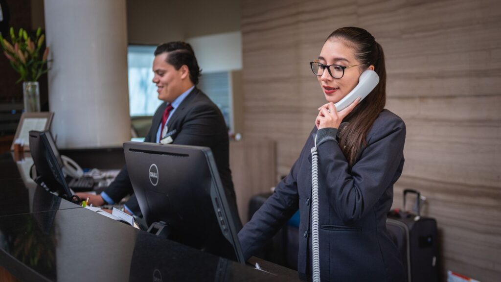 woman taking call at a reception desk