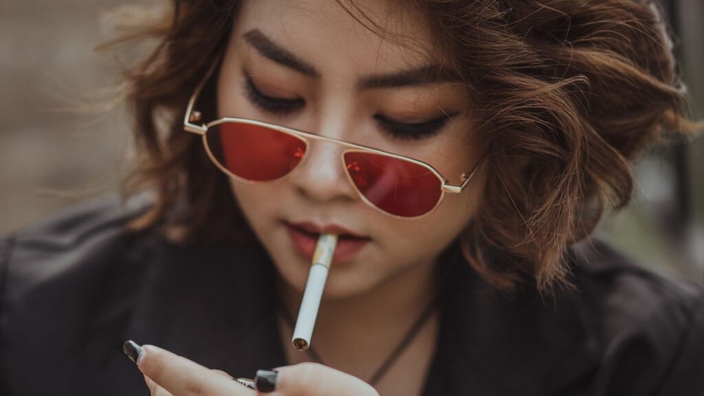 woman lighting up a cigarette