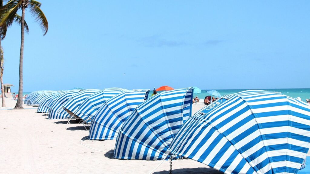 blue and white cabanas on the beach