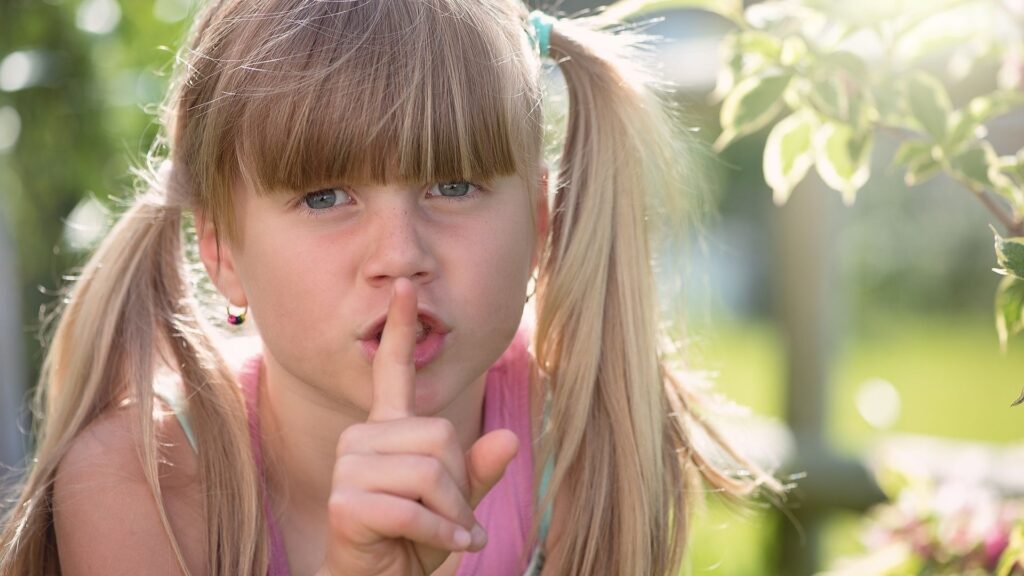 girl with finger to lips