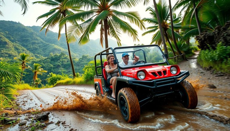 Two people in a muddy red buggy racing through a tropical jungle trail near Amber Cove